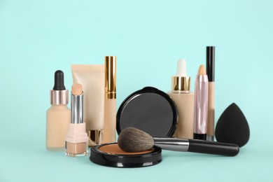 Photo of Foundation makeup products on turquoise background. Decorative cosmetics