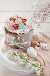 Photo of Traditional Easter cake with meringues and painted eggs on stand