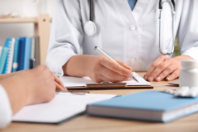 Photo of Doctors working at desk in office, closeup. Medical service