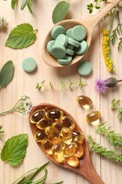 Different pills, herbs and flowers on wooden table, flat lay. Dietary supplements