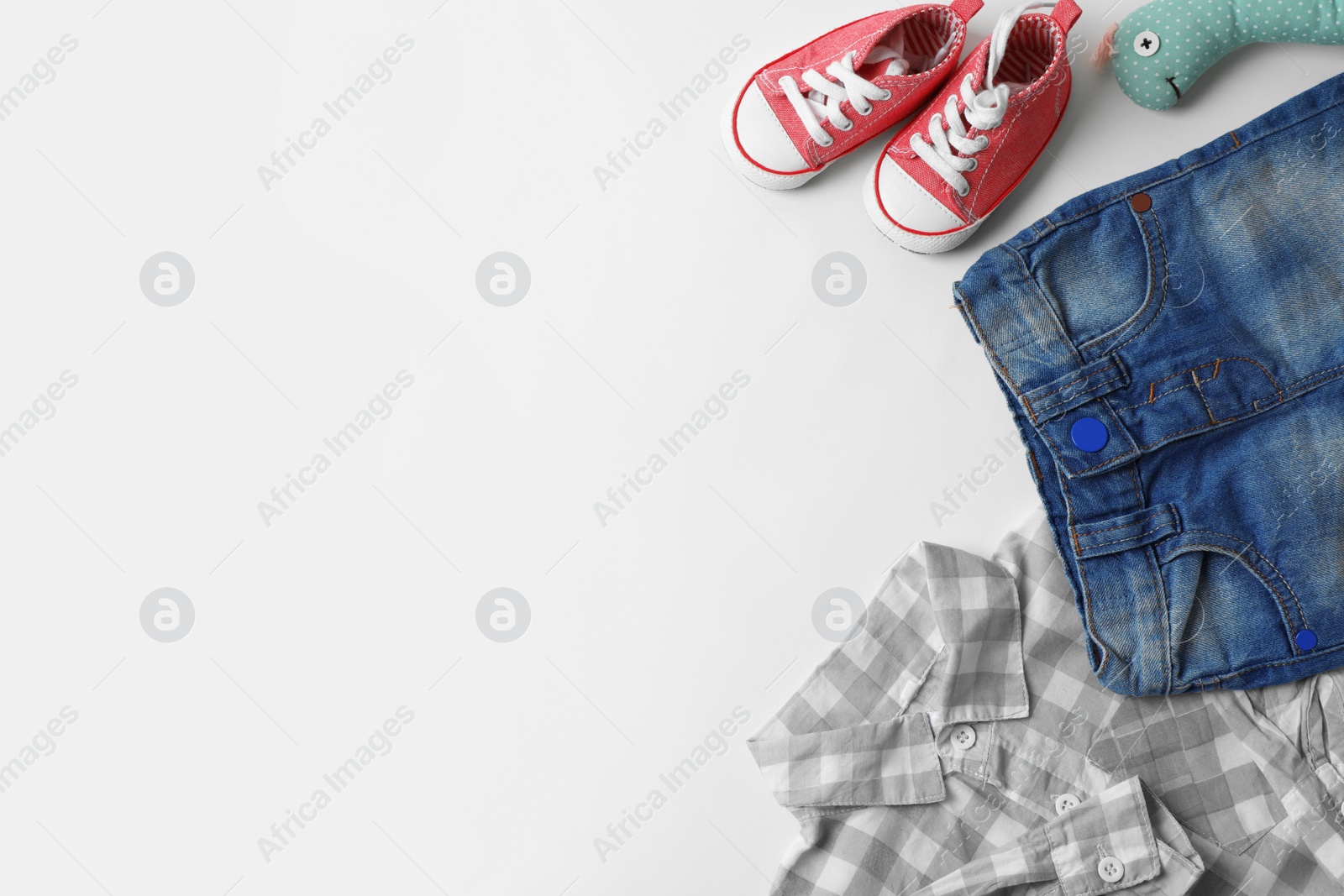 Photo of Flat lay composition with baby clothes, accessories and space for text on white background