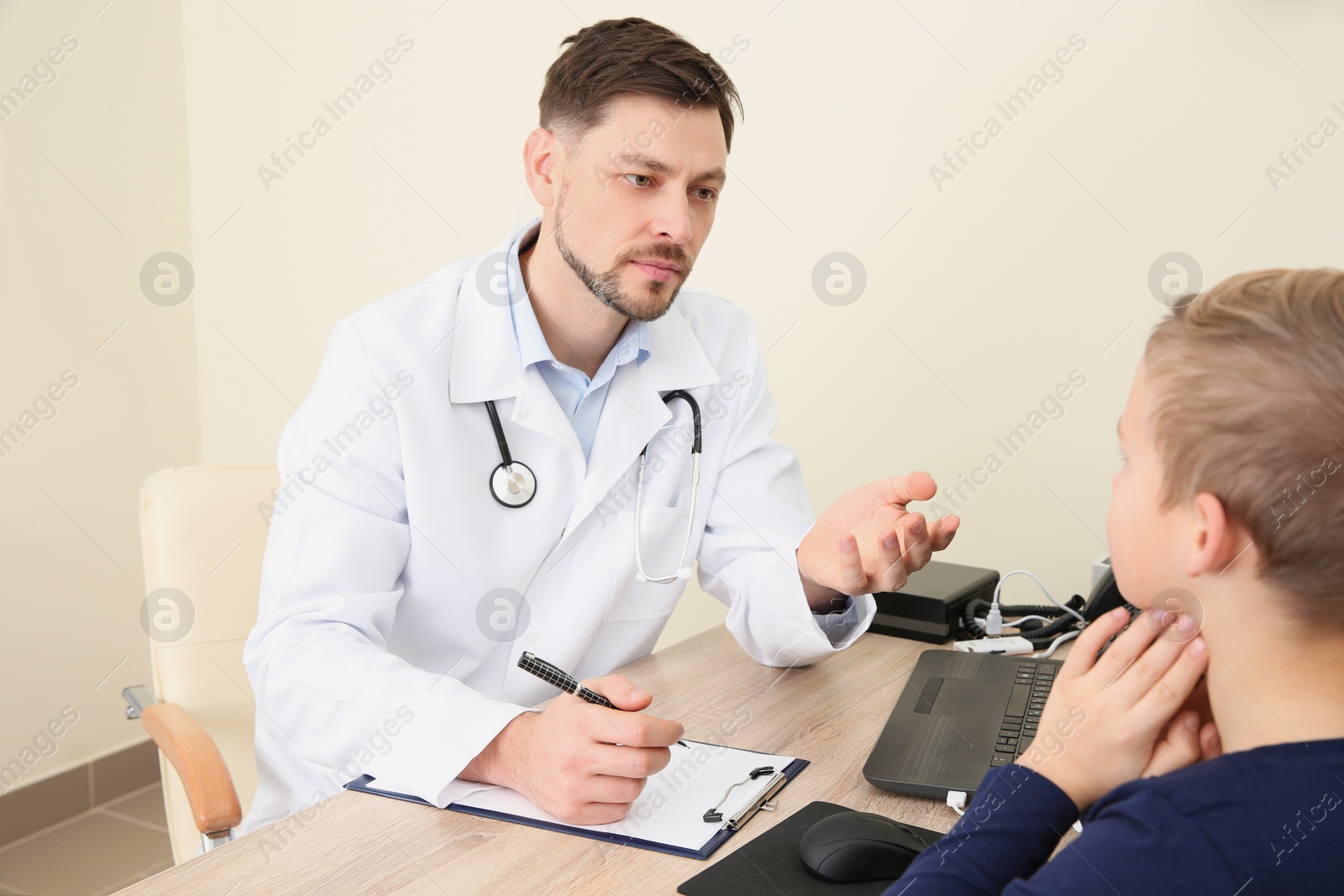 Photo of Doctor working with little child in hospital