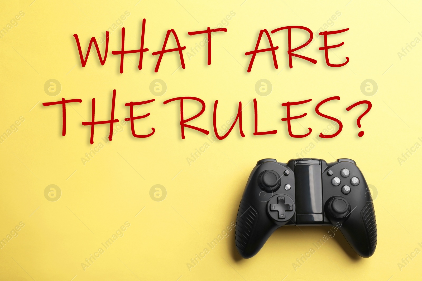 Image of Modern video game controller with text WHAT ARE THE RULES on yellow background, top view