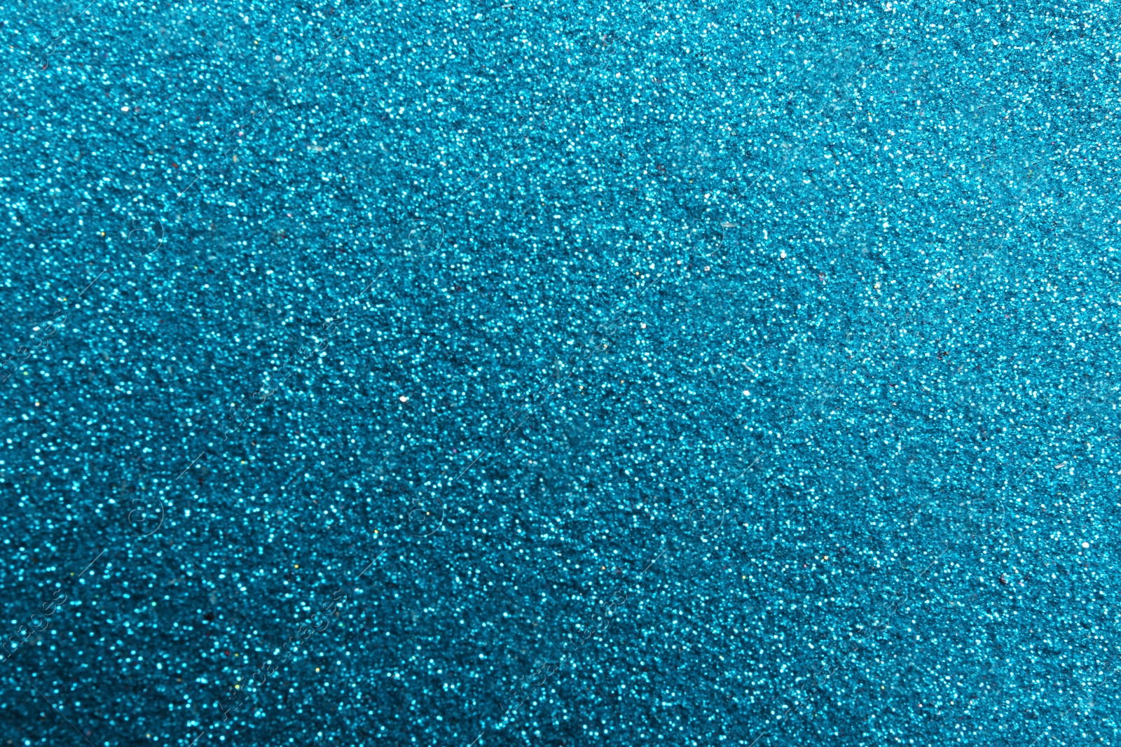 Photo of Closeup view of sparkling blue glitter background