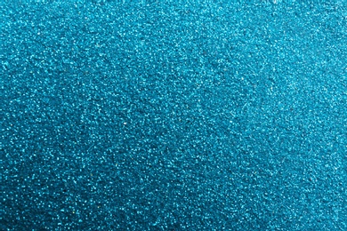 Photo of Closeup view of sparkling blue glitter background