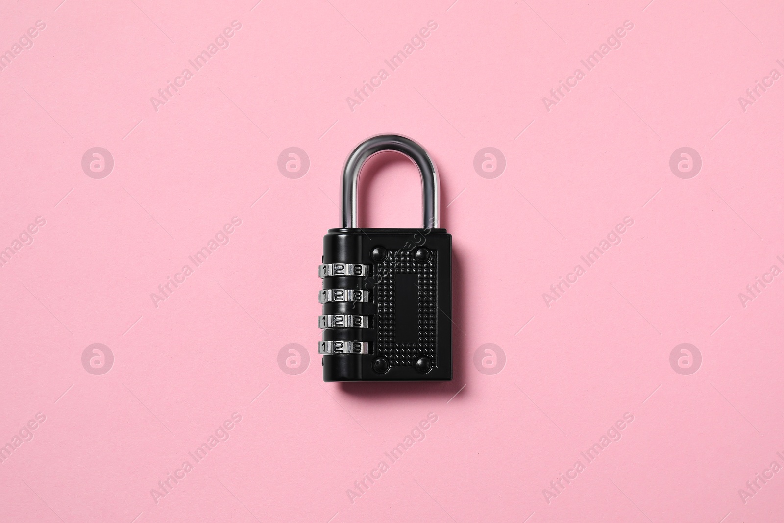 Photo of Steel combination padlock on pink background, top view