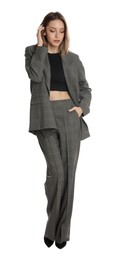 Photo of Full length portrait of beautiful young woman in fashionable suit on white background. Business attire