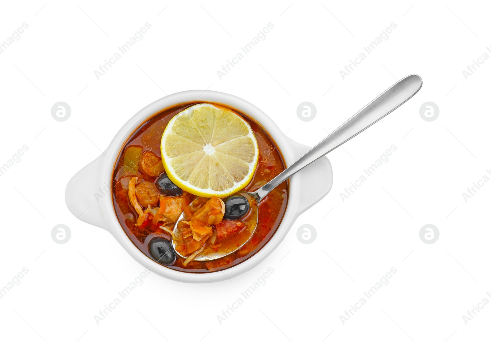 Photo of Meat solyanka soup with sausages, olives, vegetables and spoon in bowl isolated on white, top view