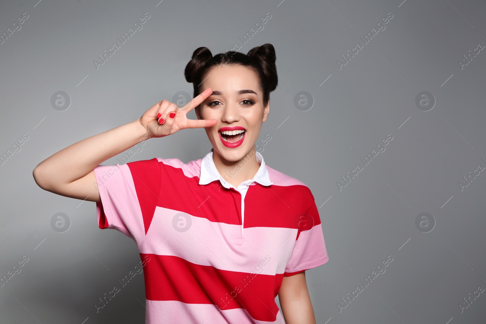 Photo of Portrait of beautiful young woman on grey background