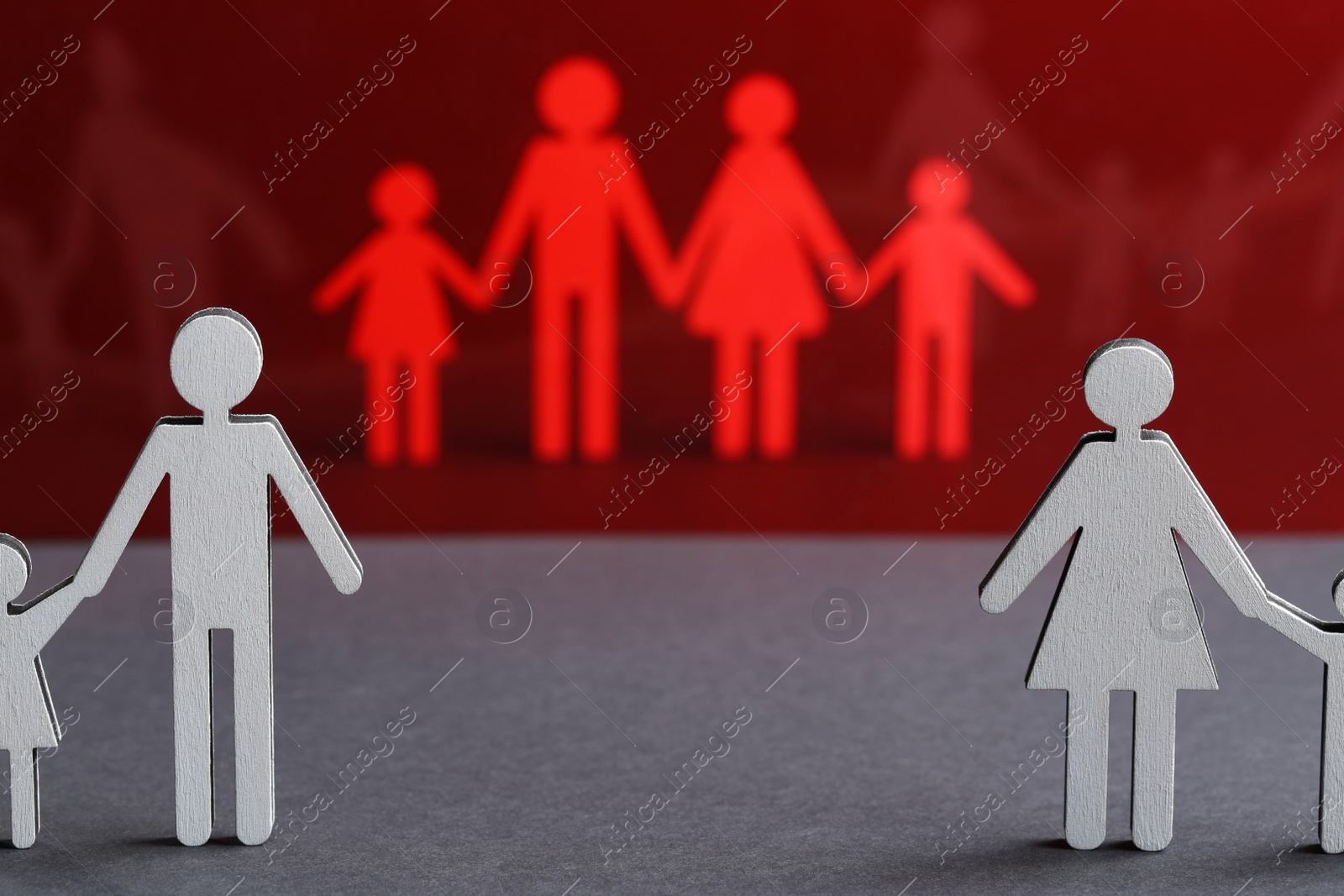 Photo of Paper figures of married and divorced family on color background