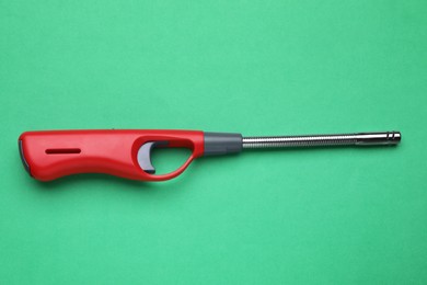 One gas lighter on green background, top view