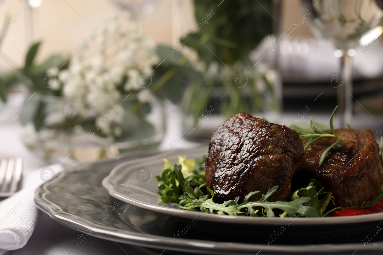 Photo of Delicious grilled meat with vegetables served on table in restaurant