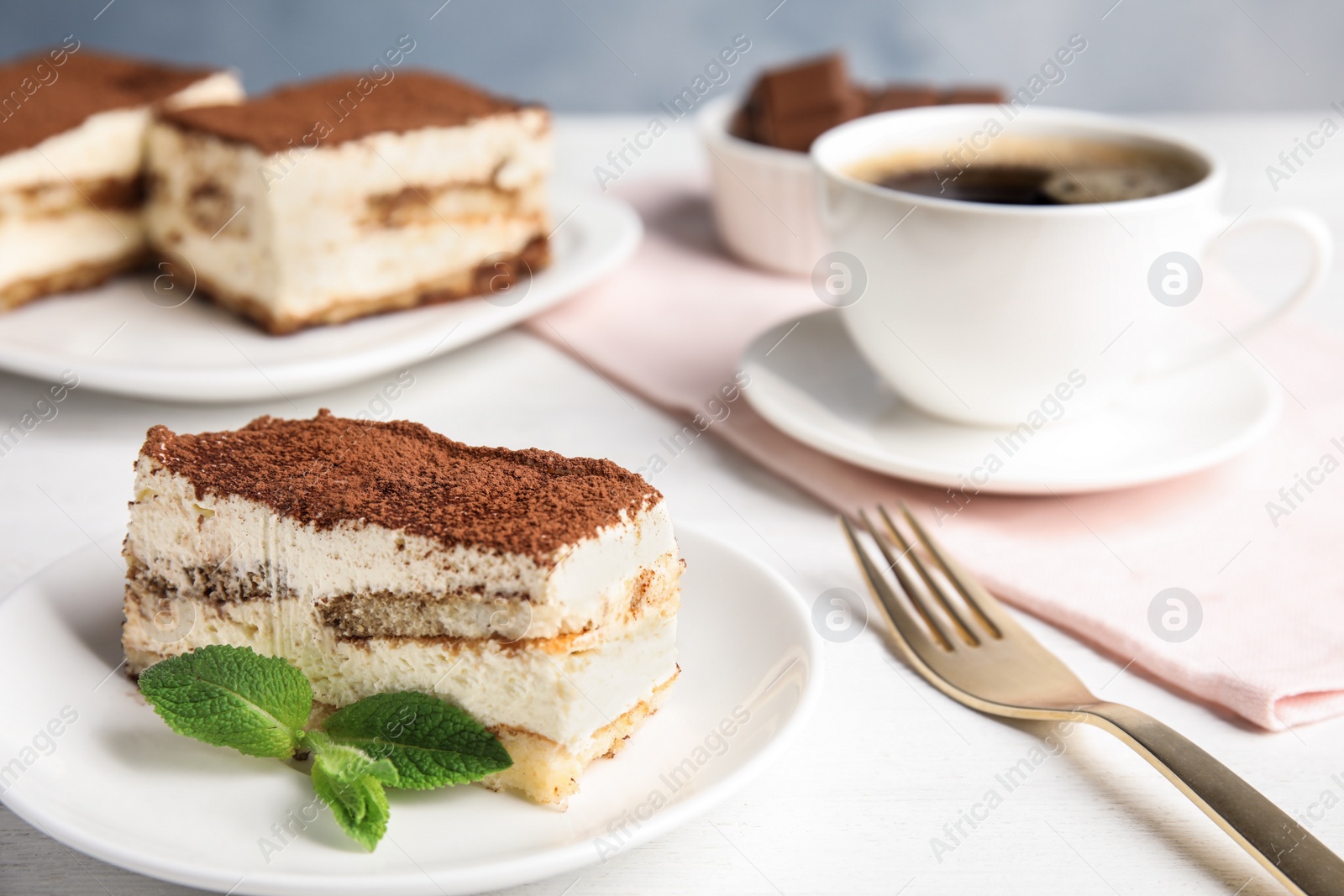 Photo of Tiramisu cake and drink served on table