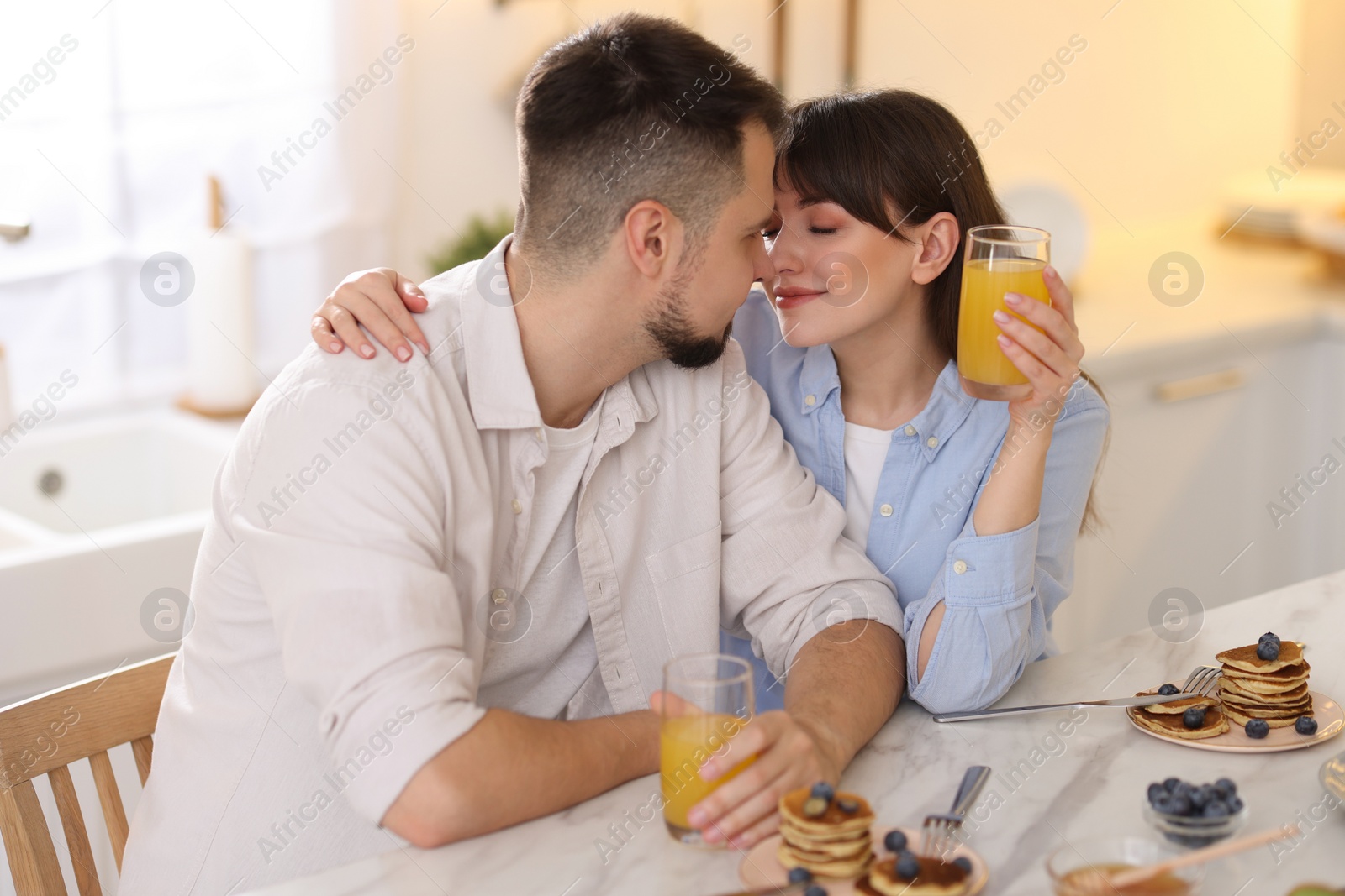 Photo of Happy couple spending time together during breakfast at home