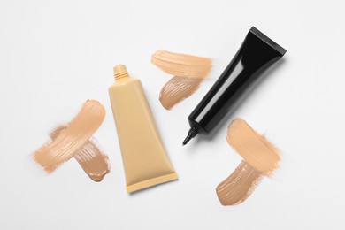 Liquid foundations and swatches on white background, flat lay