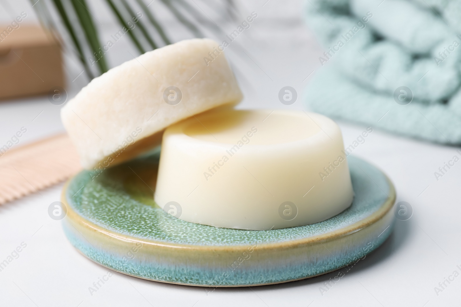 Photo of Solid shampoo bars on white table, closeup. Hair care