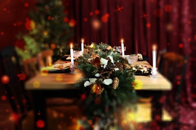 Image of Christmas table setting for festive dinner, bokeh effect. Candles, garland, plates and glasses on table indoors