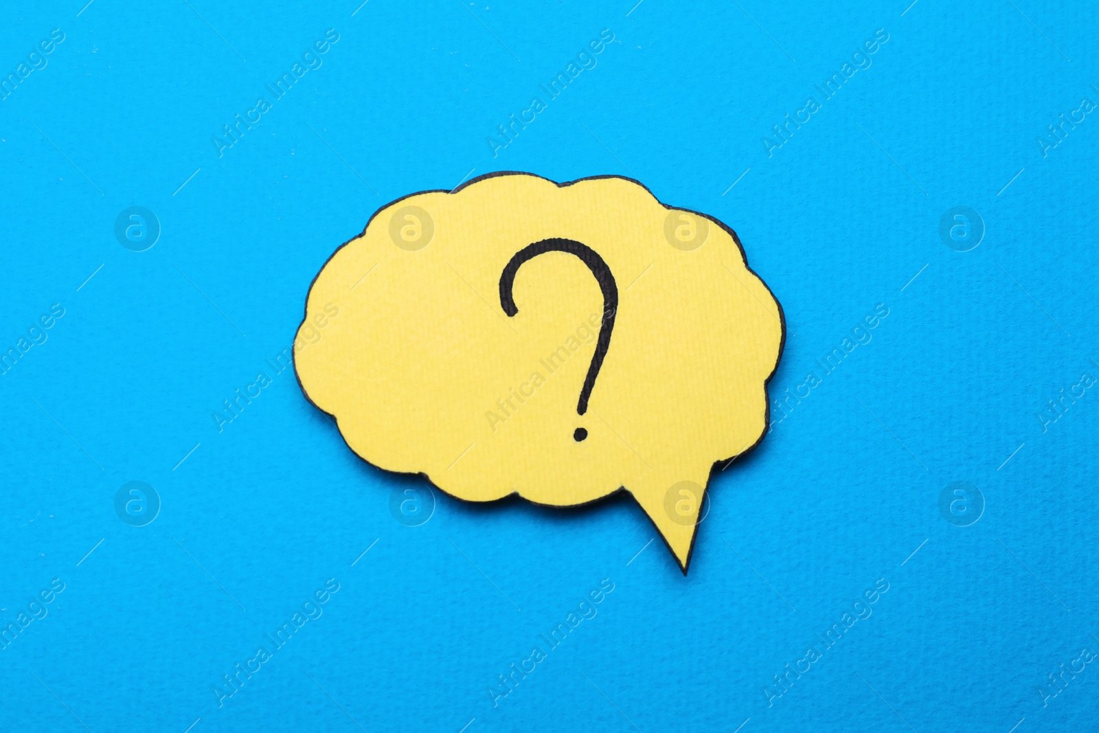 Photo of Paper speech bubble with question mark on light blue background, top view