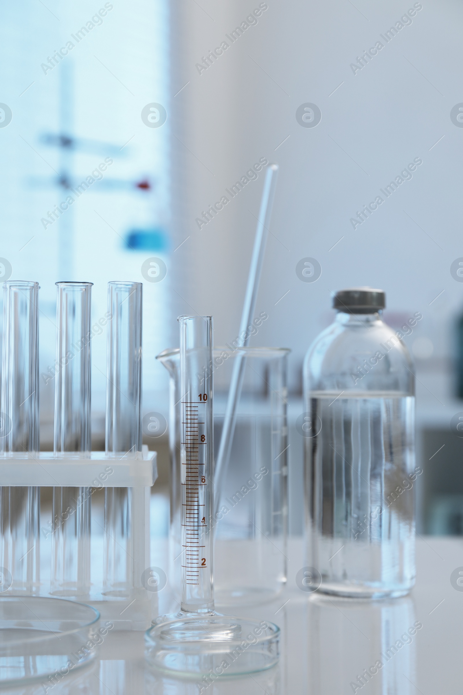 Photo of Laboratory analysis. Different glassware on white table indoors