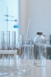 Laboratory analysis. Different glassware on white table indoors