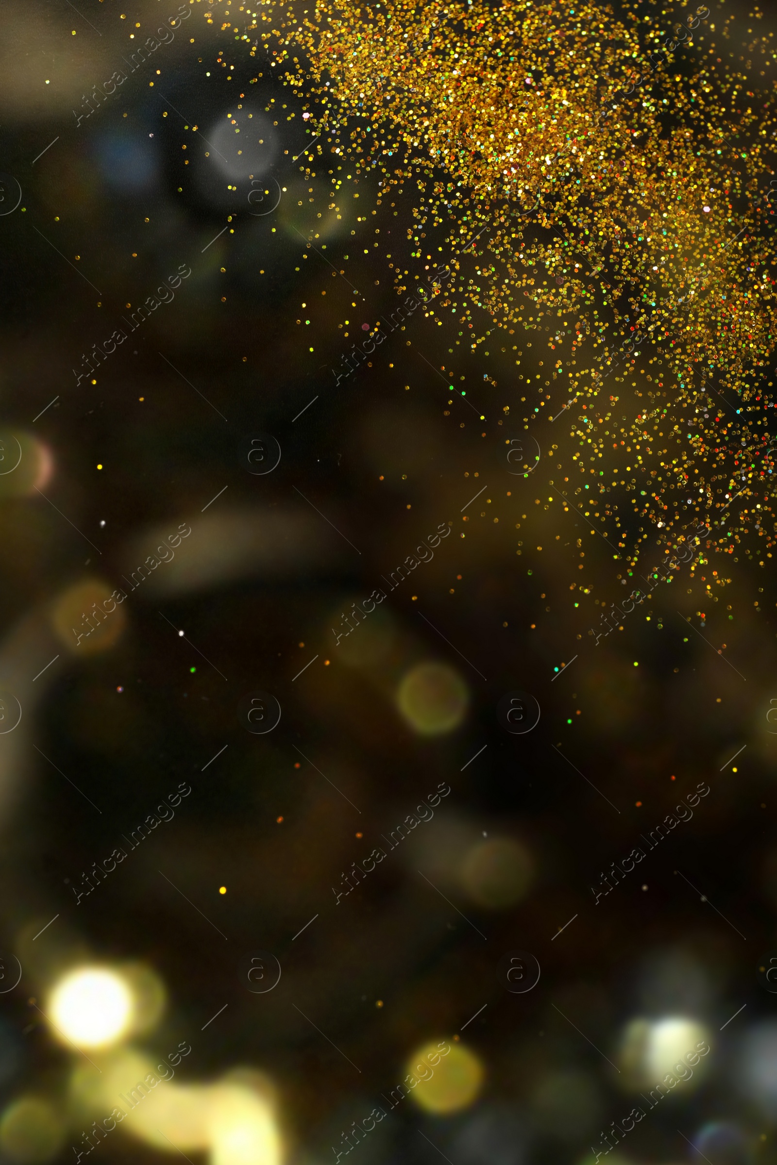 Photo of Shiny golden glitter on blurred background with bokeh effect. Space for text