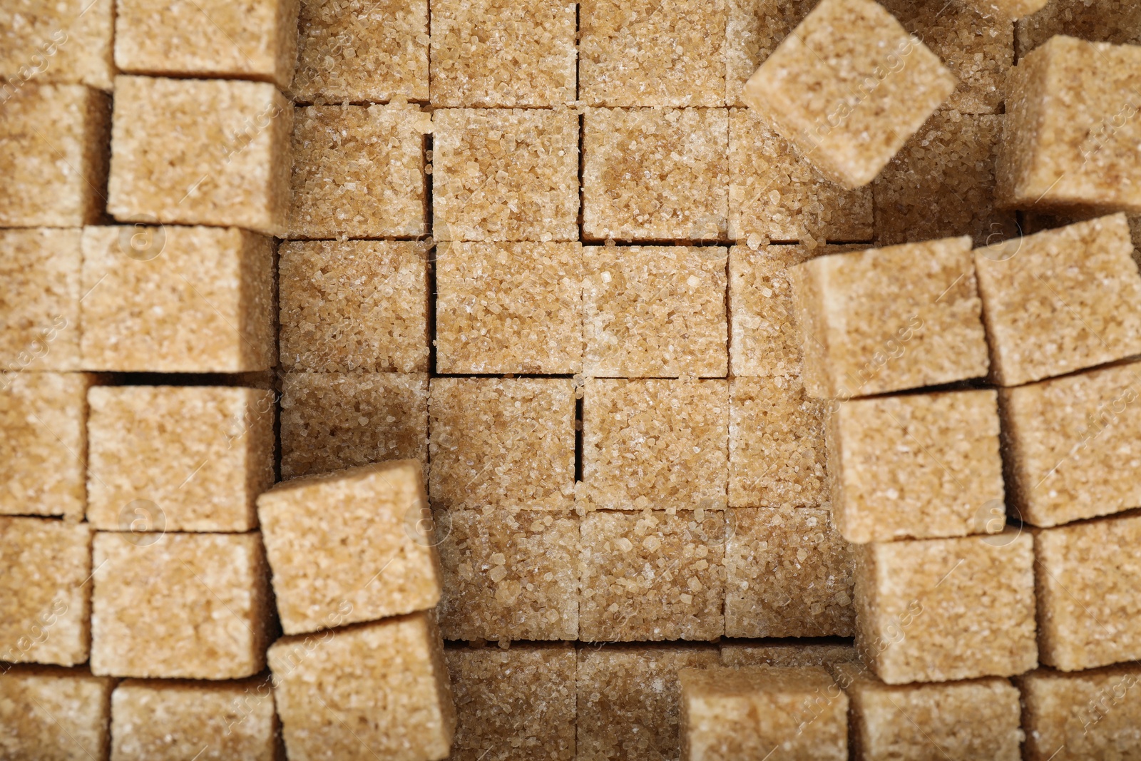 Photo of Brown sugar cubes as background, closeup view