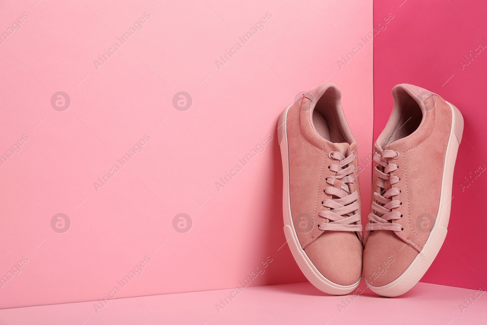 Photo of Comfortable sneakers on color background, space for text