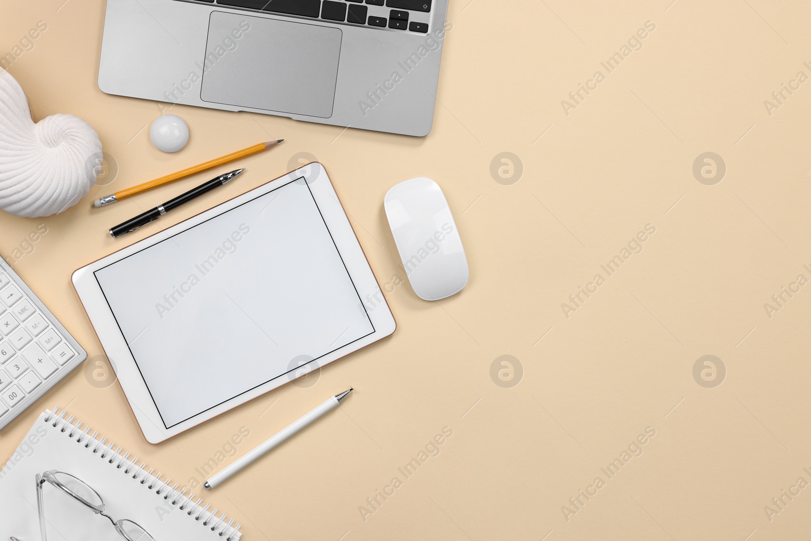 Photo of Flat lay composition with modern tablet on beige background. Space for text