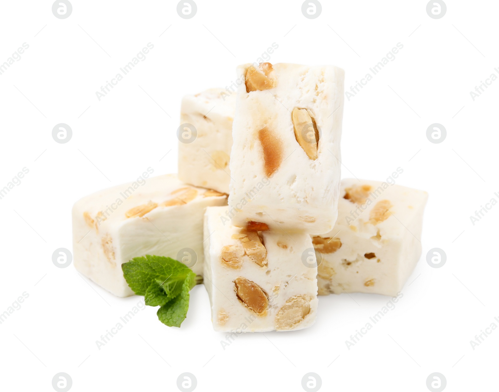 Photo of Pieces of delicious nougat and mint on white background