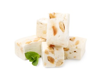 Photo of Pieces of delicious nougat and mint on white background