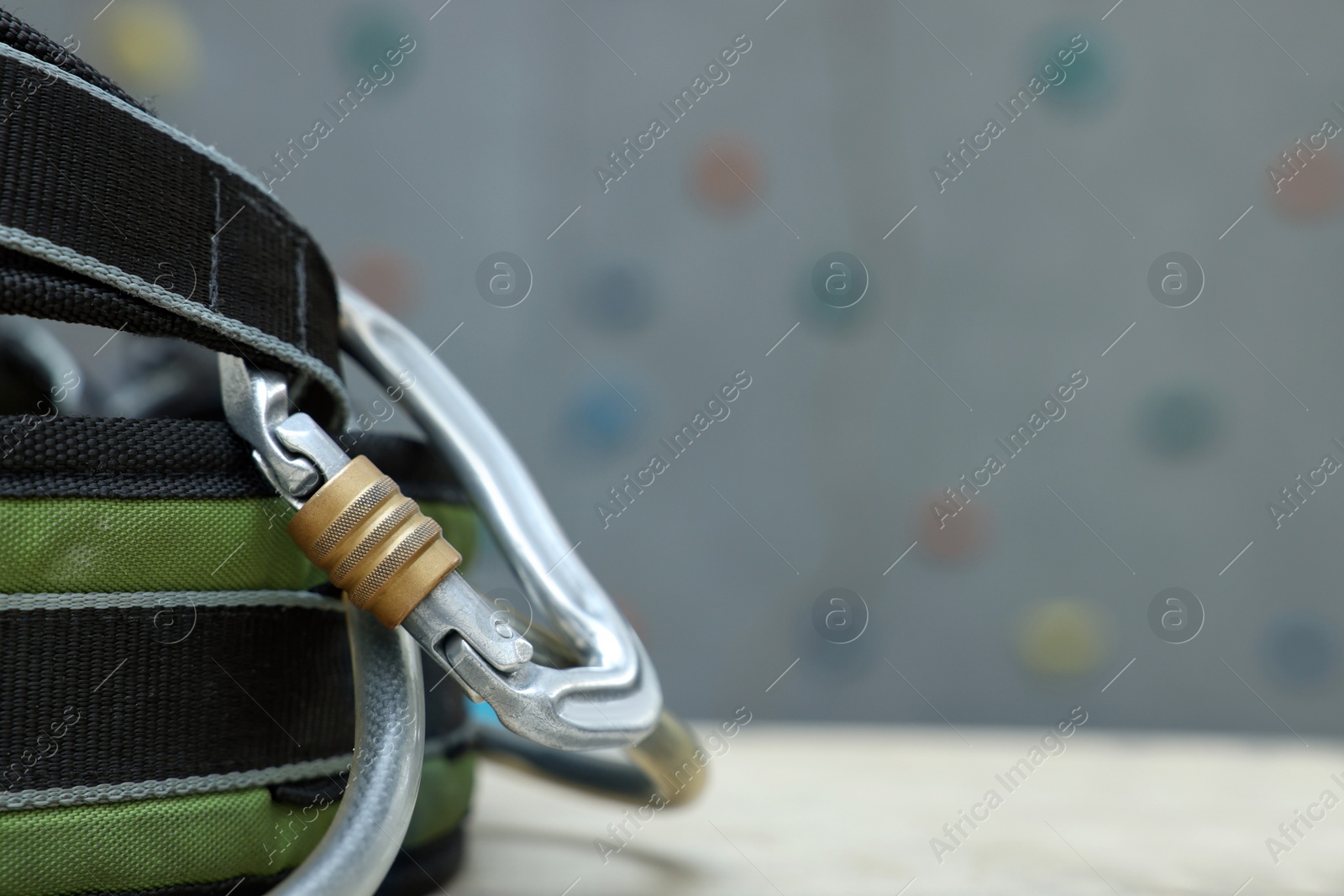 Photo of Climbing equipment on white table in gym, closeup. Space for text