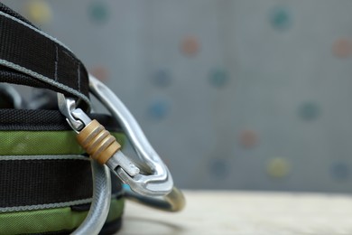 Photo of Climbing equipment on white table in gym, closeup. Space for text