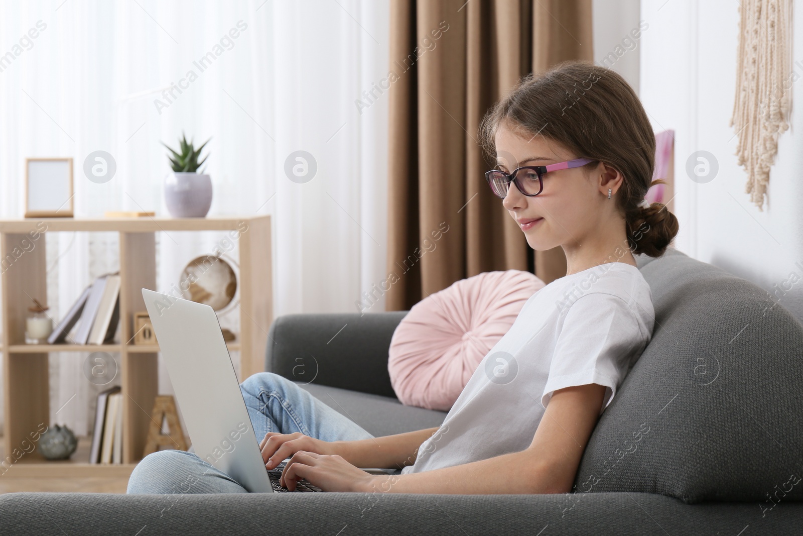 Photo of Girl with laptop on sofa at home