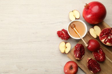 Flat lay composition with Rosh Hashanah holiday attributes on white wooden table. Space for text