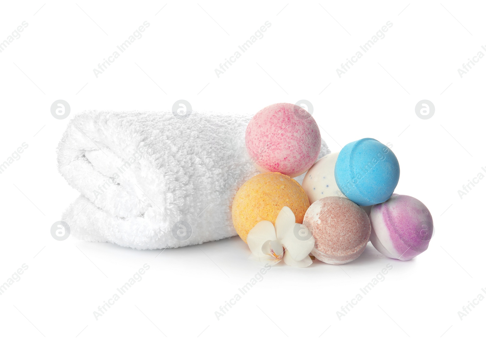 Photo of Bath bombs and towel on white background