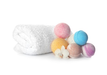 Photo of Bath bombs and towel on white background
