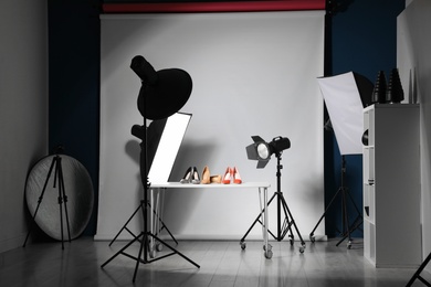 Photo of Professional photography equipment prepared for shooting stylish shoes in studio