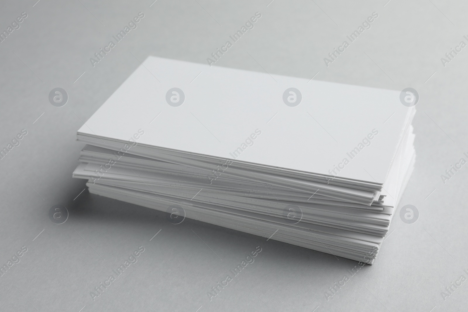 Photo of Blank business cards on light gray background, closeup. Mockup for design