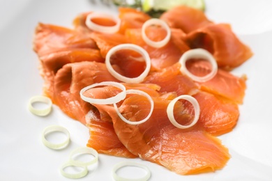 Fresh sliced salmon fillet with onion, closeup