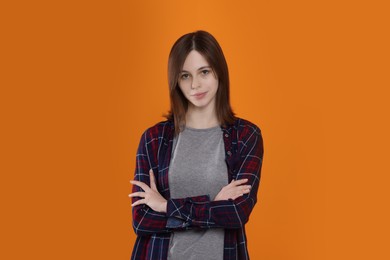 Photo of Portrait of cute teenage girl on orange background