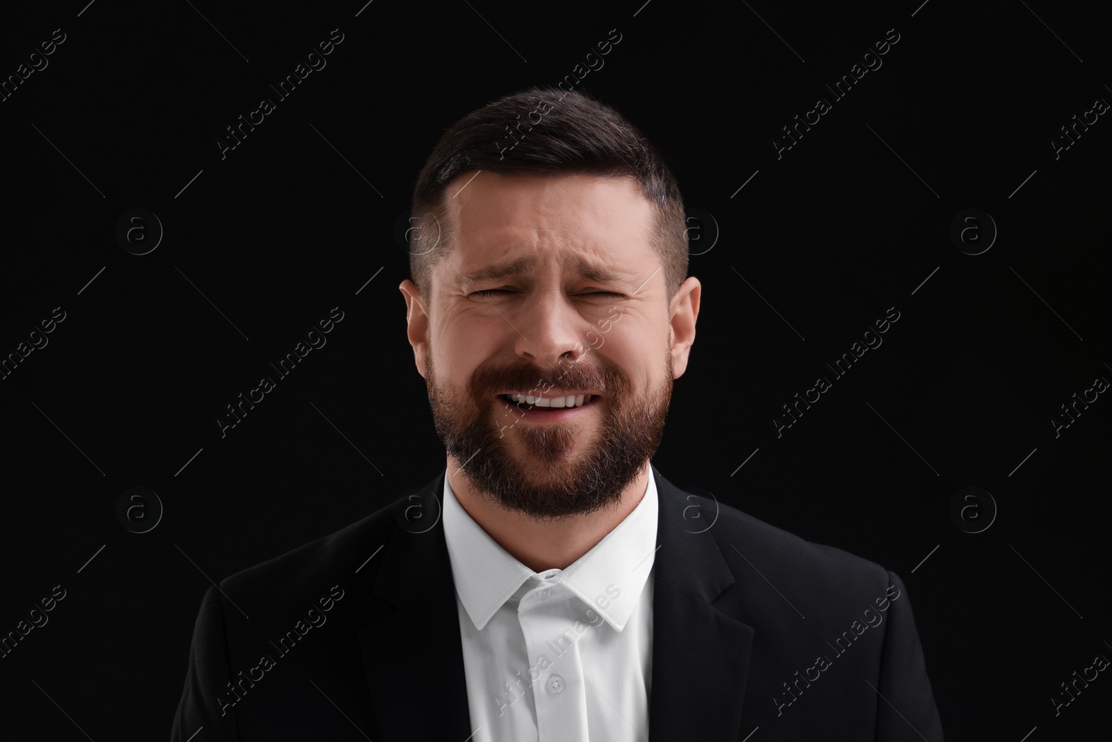 Photo of Personality concept. Emotional man on black background