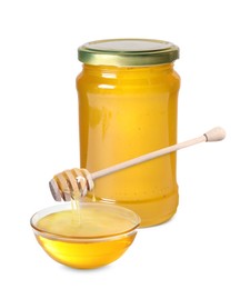 Natural honey dripping from dipper into glass bowl. Jar full of honey on white background