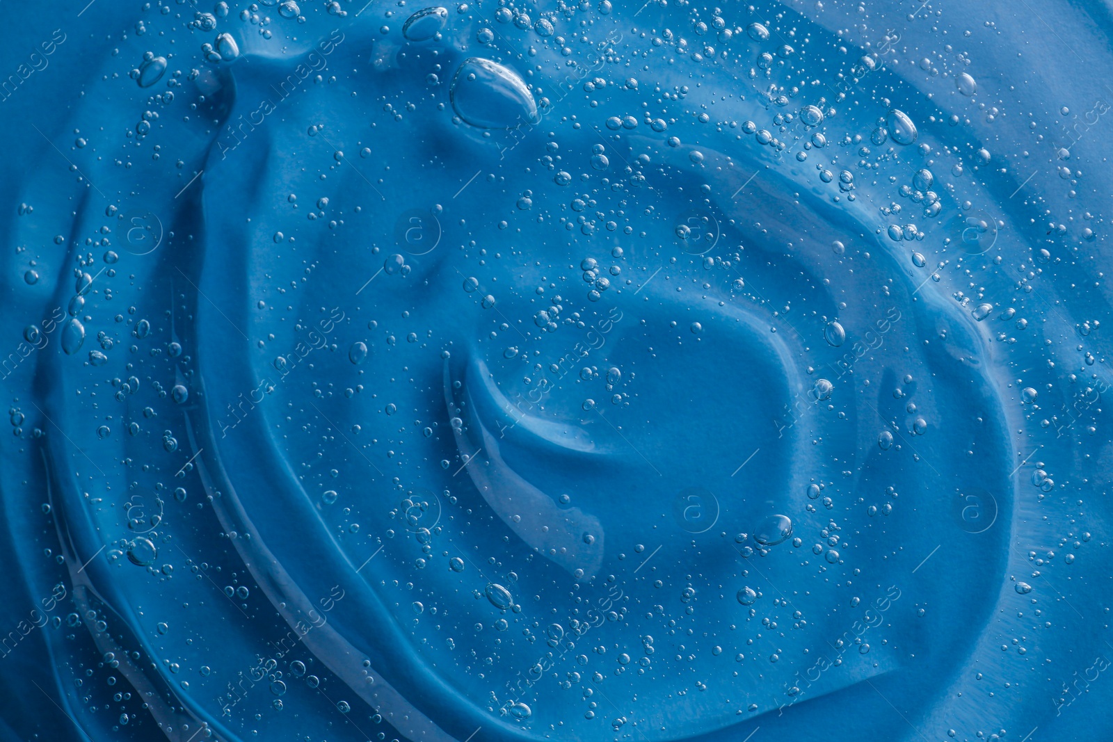 Photo of Texture of light blue shower gel as background, top view