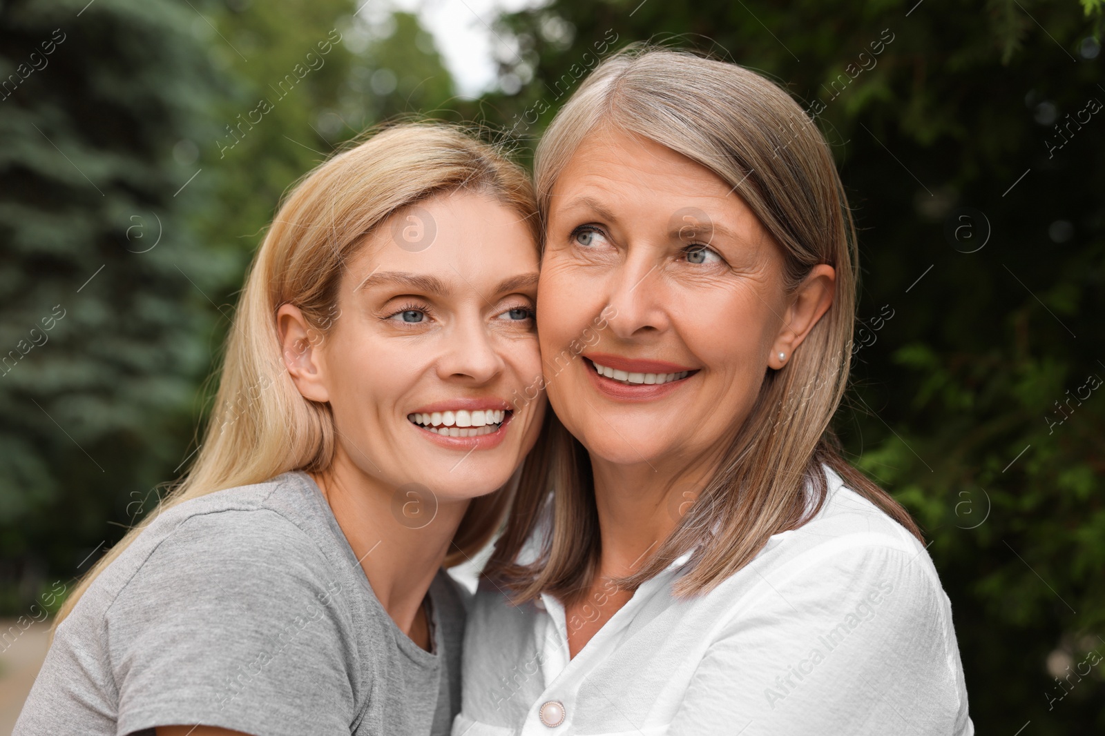 Photo of Happy mature mother and her daughter outdoors