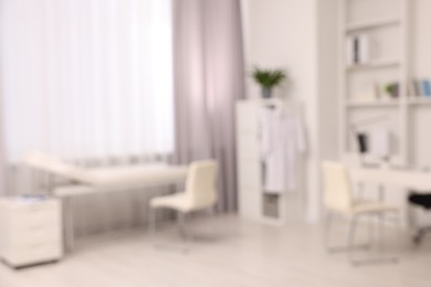 Photo of Blurred view of medical office interior with doctor's workplace
