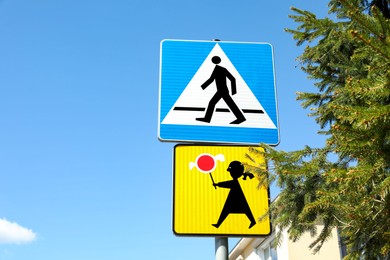 Photo of Different traffic signs against blue sky, space for text