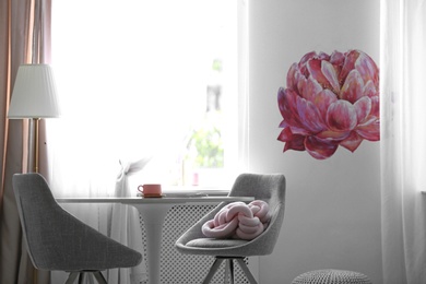 Stylish room interior with table and chairs near decorated wall