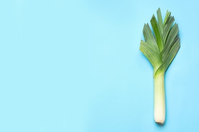 Photo of Fresh raw leek on color background, top view with space for text. Ripe onion