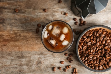 Glass with cold brew coffee on wooden background, top view