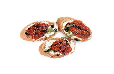 Photo of Delicious bruschettas with sun-dried tomatoes, cream cheese and balsamic vinegar isolated on white, top view